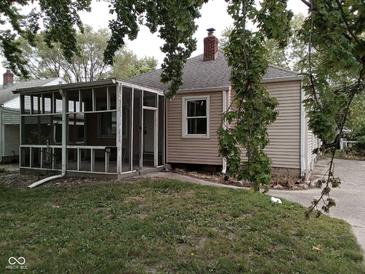 Cozy home featuring a screened-in porch and a quaint backyard at 1741 N Riley Ave, Indianapolis, IN 46218