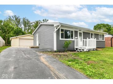 Charming single-story home with gray siding, white trim, well-maintained lawn, and a detached two car garage at 1820 Hemlock Ln, Plainfield, IN 46168