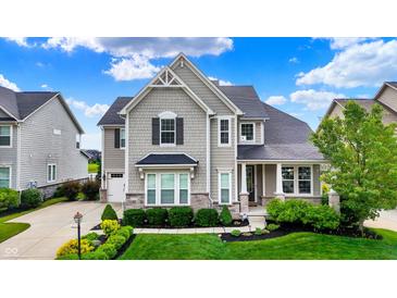Charming two-story home with manicured lawn and beautiful landscaping on a sunny day at 2789 W High Grove Cir, Zionsville, IN 46077