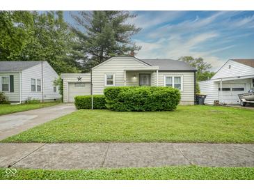 Charming home featuring a well-manicured front lawn and inviting curb appeal at 400 E 34Th St, Anderson, IN 46013
