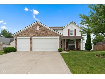 Charming two-story home with brick and white siding, a well-manicured lawn, and an attached two-car garage at 6927 Rose Tree Ct, Indianapolis, IN 46237