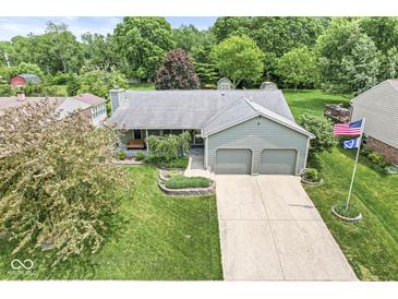 Charming home featuring a manicured lawn and two-car garage, perfect for Gathering living at 7025 Chimney Rock Ct, Indianapolis, IN 46217