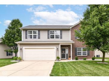 Charming two-story home with a two-car garage, complemented by a well-manicured lawn and beautiful landscaping at 7214 Morello Ln, Noblesville, IN 46062