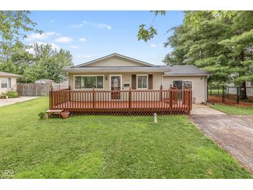 Charming single-story home featuring a large front yard and inviting wood deck at 724 Alexander St, Greenwood, IN 46143