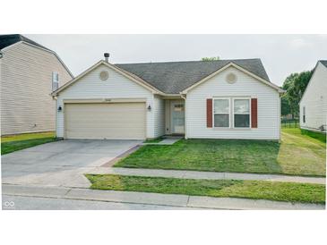 Charming single-story home with a well-maintained lawn and attached two-car garage at 8148 Gathering Cir, Indianapolis, IN 46259