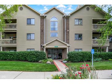 Well-maintained condo building with manicured landscaping and accessible entrance at 8720 Yardley Ct # 108, Indianapolis, IN 46268