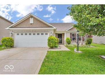 Charming single-story home with a well-manicured lawn and attached two car garage at 11254 N Sashing Way, Monrovia, IN 46157