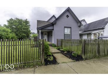 Charming two-story home featuring a well-maintained lawn and inviting walkway at 1201 Villa Ave, Indianapolis, IN 46203