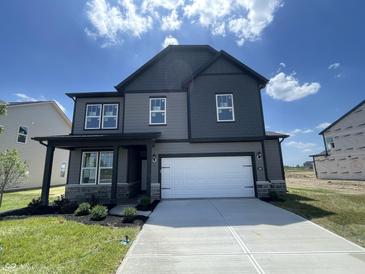 Beautiful new two-story home featuring a two-car garage, stone accents, and a well-manicured lawn at 16465 Mount Logan Rd, Noblesville, IN 46060