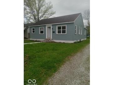 Charming single-story home with light blue siding and a well-manicured front lawn at 3626 N Denny St, Indianapolis, IN 46218