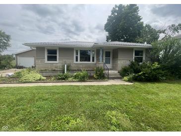 Charming home featuring a well-maintained lawn and pleasing stone and siding combination at 4363 Roosevelt Dr, Columbus, IN 47201