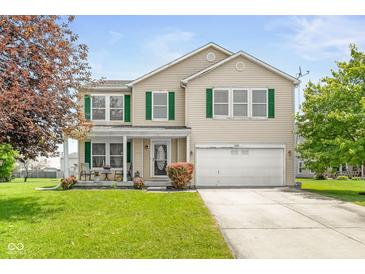 Charming two-story home featuring green shutters, a well-manicured lawn, and an attached two-car garage at 5631 N Peppereel Way, McCordsville, IN 46055