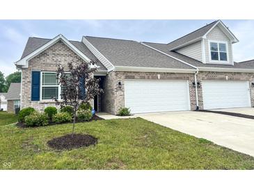 Charming townhome with brick facade, two-car garage, and freshly landscaped front yard at 6350 Stallion Way, Indianapolis, IN 46260
