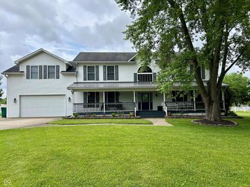 Charming two-story home with a well-manicured lawn and a welcoming front porch perfect for relaxing at 7195 W 700 N, Fairland, IN 46126