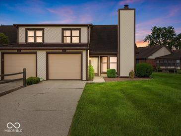 Inviting townhome with attached two-car garage and well-manicured lawn at 1205 Cypress Dr, Shelbyville, IN 46176