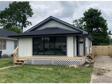 Charming renovated bungalow showcasing new siding, deck and manicured lawn, inviting comfort and modern curb appeal at 1429 Udell St, Indianapolis, IN 46208