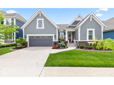 Charming home featuring a gray exterior, well-manicured lawn, and inviting curb appeal with a gray two car garage at 1505 Avondale Dr, Westfield, IN 46074