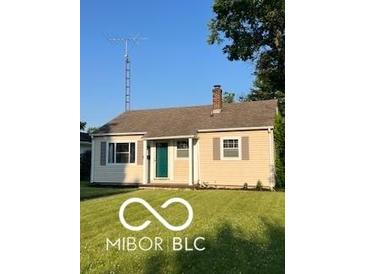 Charming single-story home with green lawn and neutral siding, enhanced by a traditional chimney at 2028 Gilmore St, Columbus, IN 47201