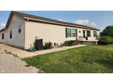 Charming single-story home featuring green shutters, lovely landscaping, and a cozy front porch at 4815 N 500 W, Columbus, IN 47201