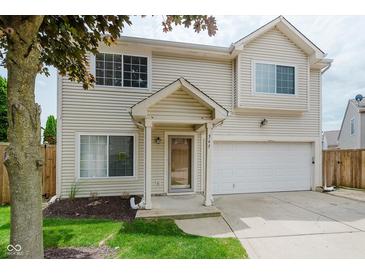 Charming two-story home with a well-manicured lawn, attached two-car garage and inviting front porch at 565 Cembra Dr, Greenwood, IN 46143