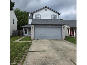 Two-story home featuring a gray two-car garage, gray roof, and gray and white siding at 6368 Titania Dr, Indianapolis, IN 46236