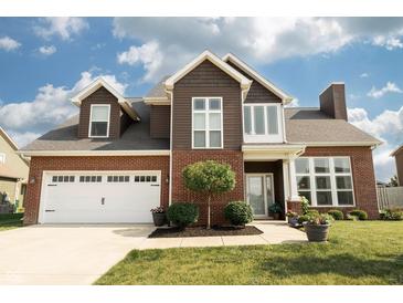 Charming two-story home with a brick and brown wood exterior and a manicured front lawn at 750 Trillium St, Lebanon, IN 46052