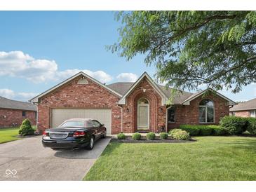Charming brick home with manicured lawn, two-car garage, and well-maintained landscaping at 1027 Plum St # 39, Brownsburg, IN 46112