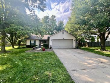Charming single-story home with a well-maintained lawn and a two car garage at 108 Meadowview Dr, Mooresville, IN 46158