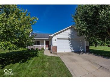 Charming single-story home with a well-manicured lawn and attached two-car garage at 11830 Sand Creek Blvd, Fishers, IN 46037