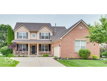 Charming two-story home featuring a covered front porch and a well-maintained lawn at 12679 Chargers Ct, Fishers, IN 46037