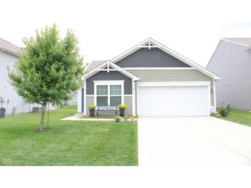 Charming one-story home with a well-manicured lawn and a two-car garage, offering great curb appeal at 12901 N Collett Way, Camby, IN 46113