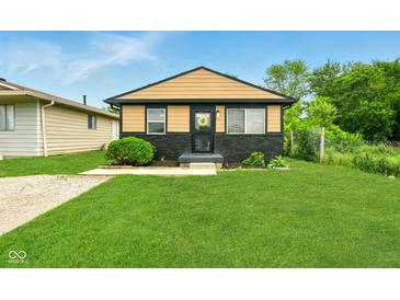 Charming single Gathering home with manicured lawn, neutral paint scheme and welcome wreath on the front door at 1513 S Rural St, Indianapolis, IN 46203