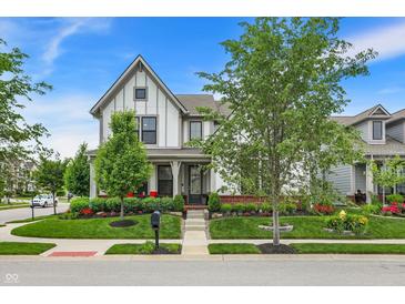 Charming two-story home with beautiful landscaping, mature trees, and a welcoming front porch at 1586 Mairn Ave, Carmel, IN 46032