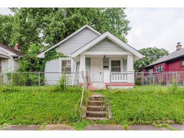Charming home featuring a covered front porch and a well-manicured front yard at 1938 N Dearborn St, Indianapolis, IN 46218