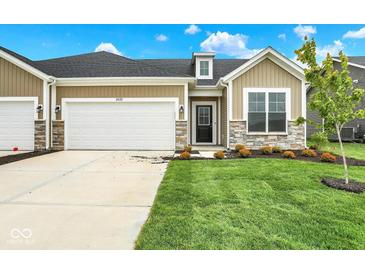 Charming single-Gathering home featuring a well-manicured lawn, stone accents, and an attached two-car garage at 2035 Frost Line Ln, Greenfield, IN 46140