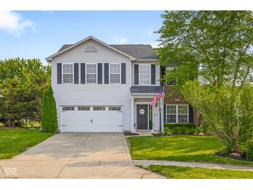 Charming two-story home featuring a well-maintained lawn and an attached two-car garage at 2247 Rolling Hill Ct, Columbus, IN 47201