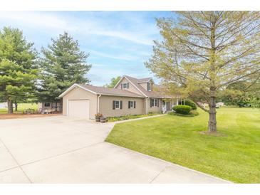 Inviting home with a charming yard, mature trees, and an attached garage offering both beauty and functionality at 391 W 500 S, Anderson, IN 46013