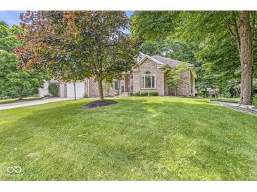 Charming single-story brick home with a well-manicured lawn and mature trees at 545 Pitney Dr, Noblesville, IN 46062