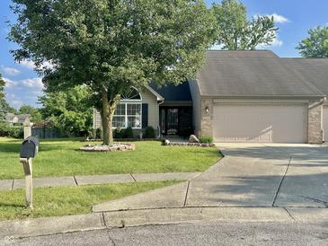 Charming single-story home with a well-maintained lawn and a two-car attached garage at 6027 Crystal View Dr, Indianapolis, IN 46237