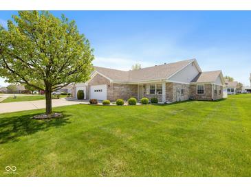 Charming brick home with well-manicured lawn and mature landscaping at 7687 Sea Crest N Way, Noblesville, IN 46062