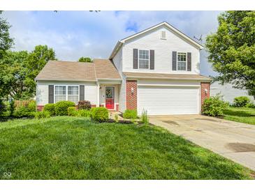 Charming two-story home with a well-manicured lawn and a two-car garage at 852 Yellowwood Dr, Greenwood, IN 46143