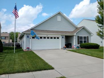 Charming single-Gathering home featuring a two-car garage, well-manicured lawn, and flag at 878 Sommersweet Run, Greenwood, IN 46143