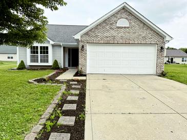 Charming single-Gathering home with a well-maintained lawn, brick accents, and a two-car garage at 883 Halyard Dr, Avon, IN 46123