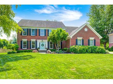 Charming two-story brick home with a well-manicured lawn and traditional architectural details at 10717 Windermere Blvd, Fishers, IN 46037