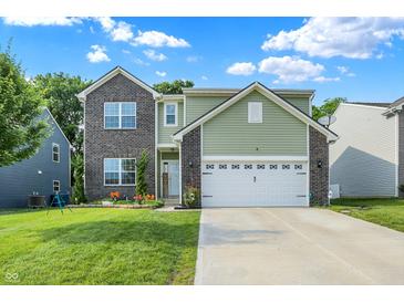 Charming two-story home with a landscaped yard and a brick and siding exterior at 10902 Jimmy Lake Dr, Indianapolis, IN 46239