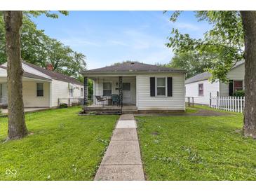 Charming single-story home featuring a front porch and well-maintained lawn and sidewalk at 1116 N Berwick Ave, Indianapolis, IN 46222