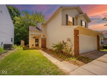 Charming two-story home features a brick accent, a well-manicured lawn, and an attached two-car garage at 1139 Maple Stream Dr, Indianapolis, IN 46217