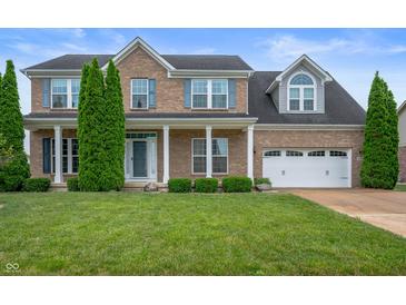 Charming brick two-story home with manicured lawn and curb appeal at 1143 Hampton Dr, Greenwood, IN 46143