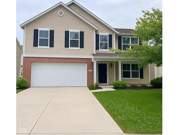 Charming two-story home with a well-maintained lawn and a two car garage at 12328 Quarry Face Ct, Fishers, IN 46037