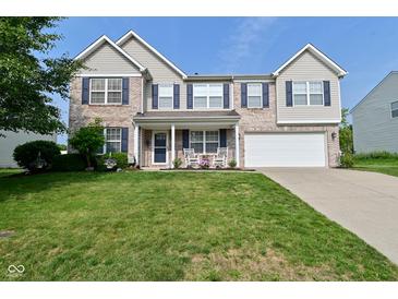 Charming two-story home with brick facade, well-manicured lawn, and inviting front porch at 1744 Salina Dr, Avon, IN 46123